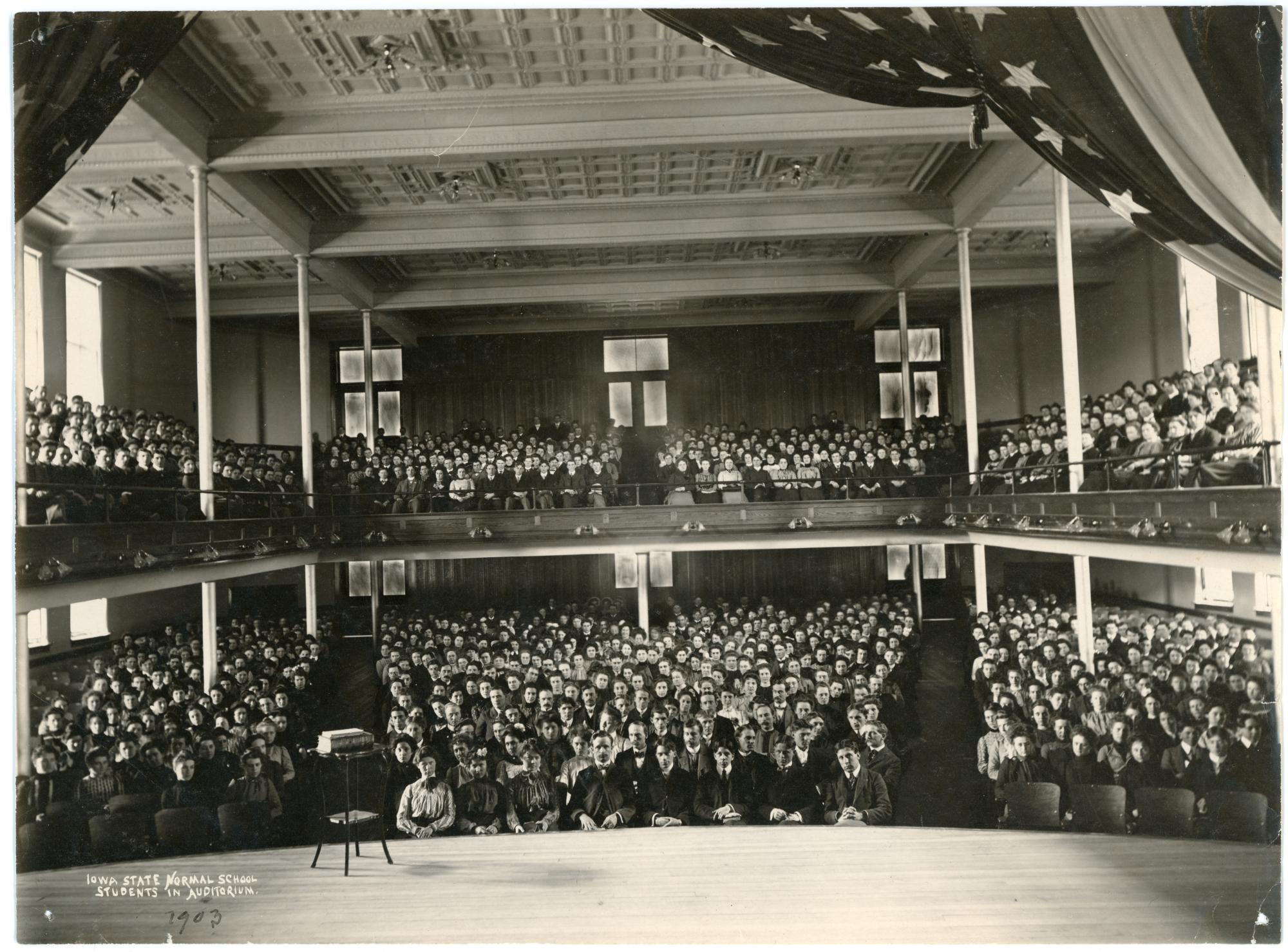 Photograph of the Lang Hall auditorium during dedication ceremony, almost all of the seats are full