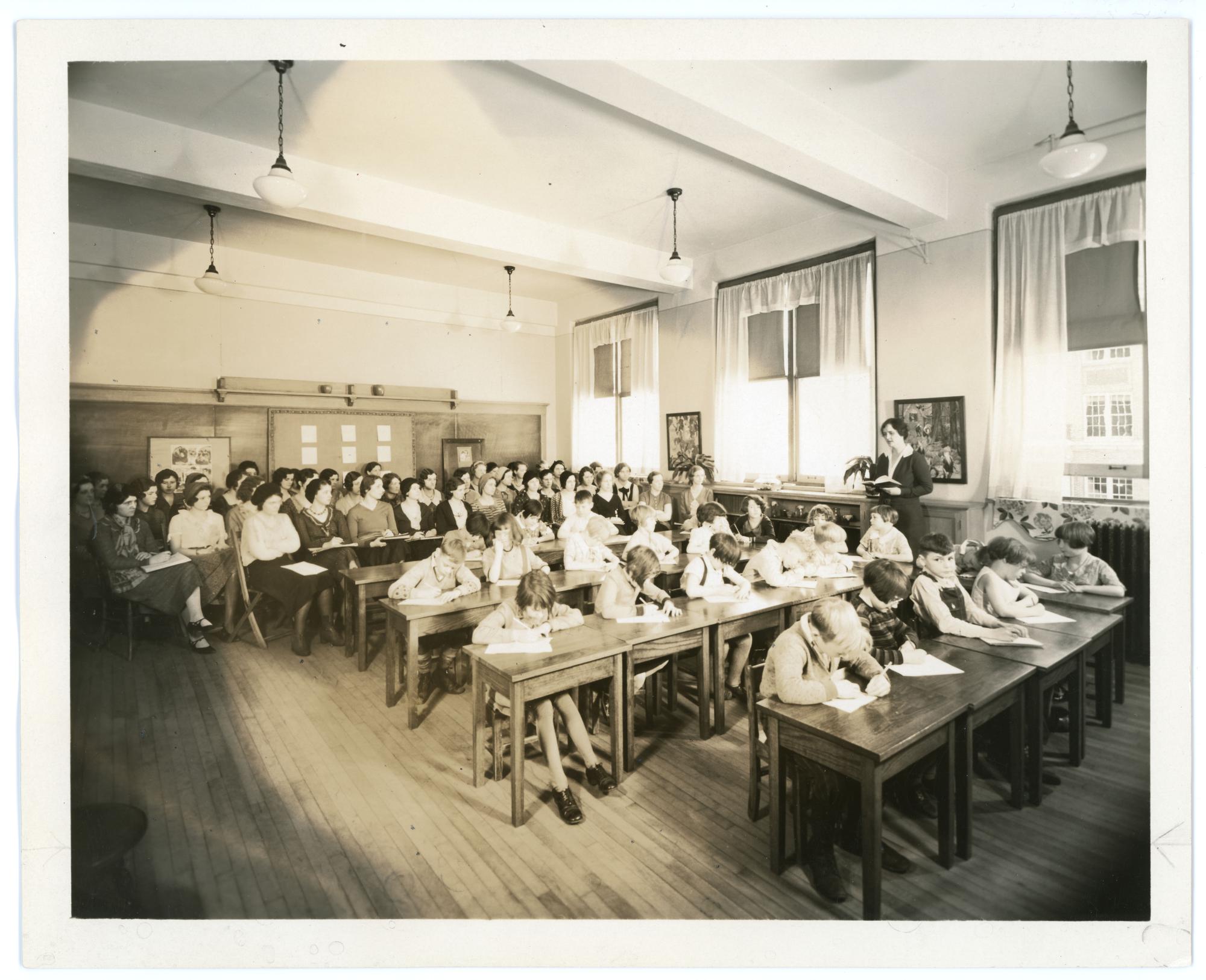 Several teaching students observing a class in a Training School classroom