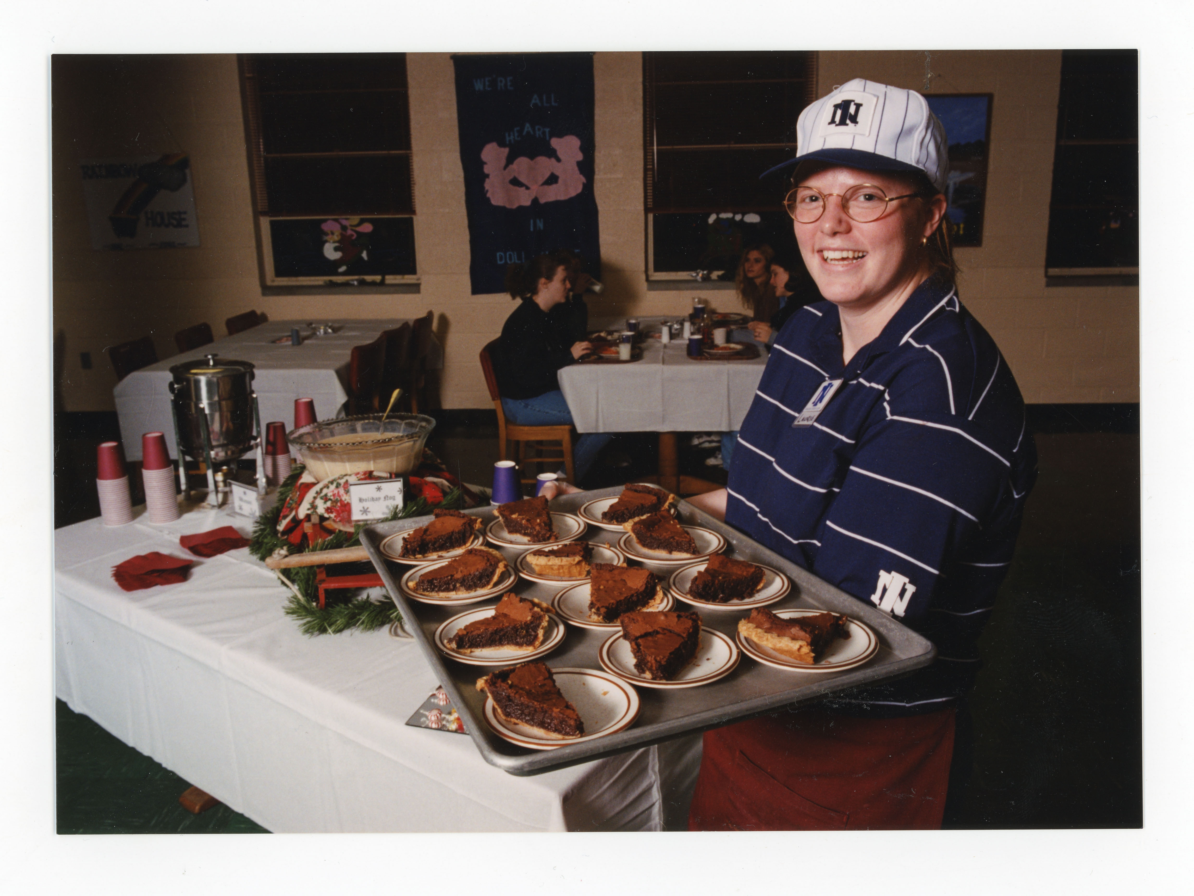 Man putting out tray of pie in dining room