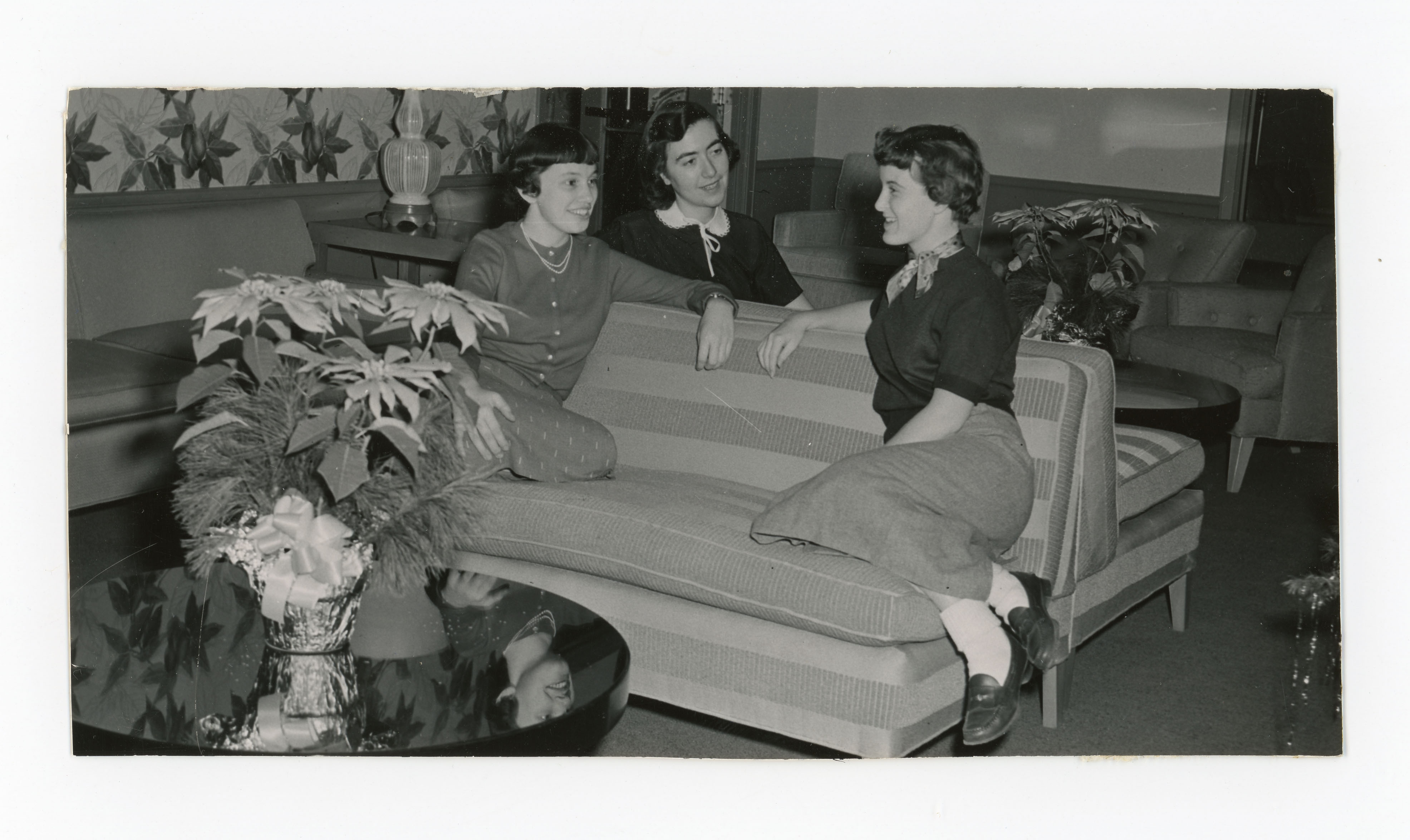 Three women talking on couches