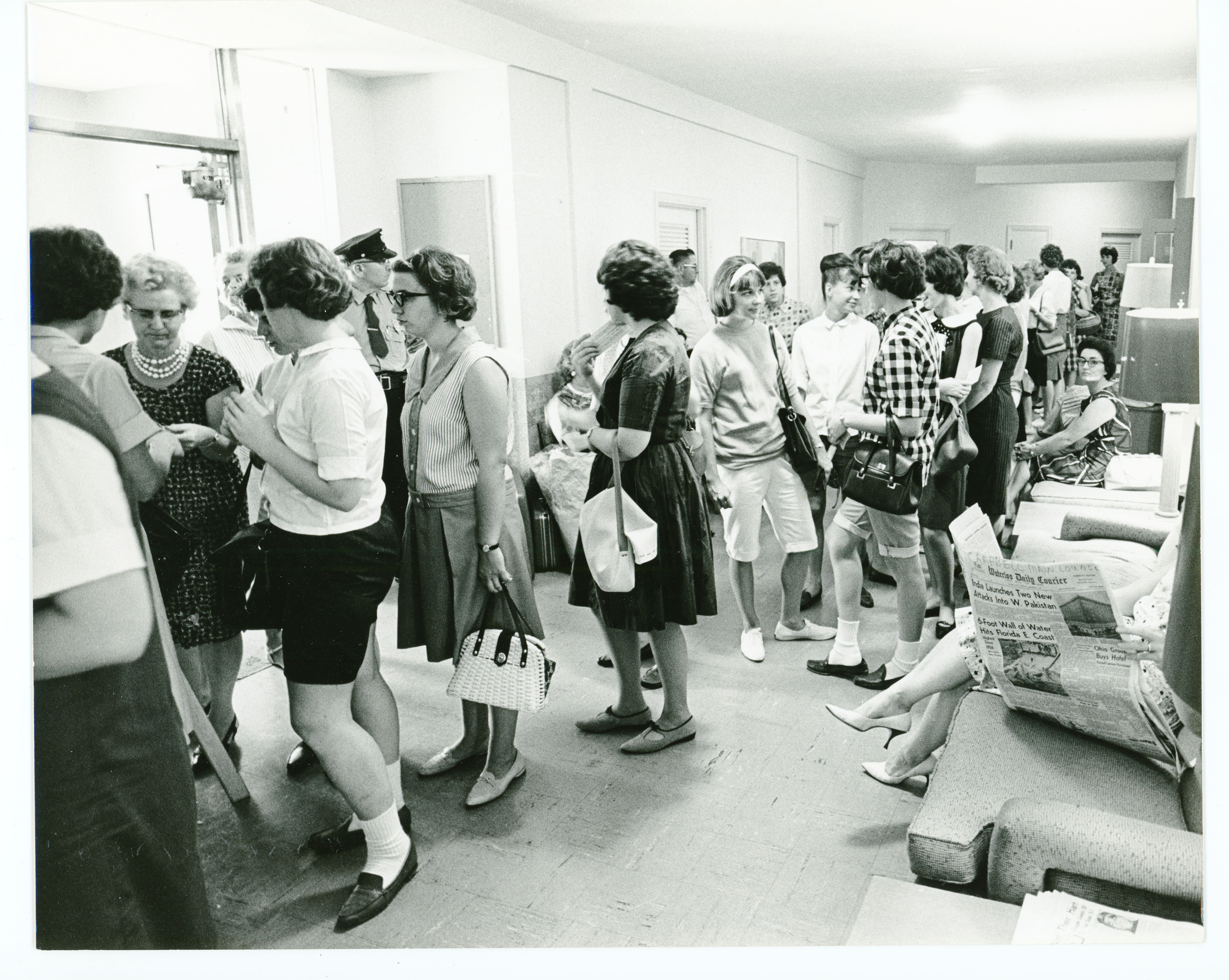 Crowd of women standing in line in a hallway