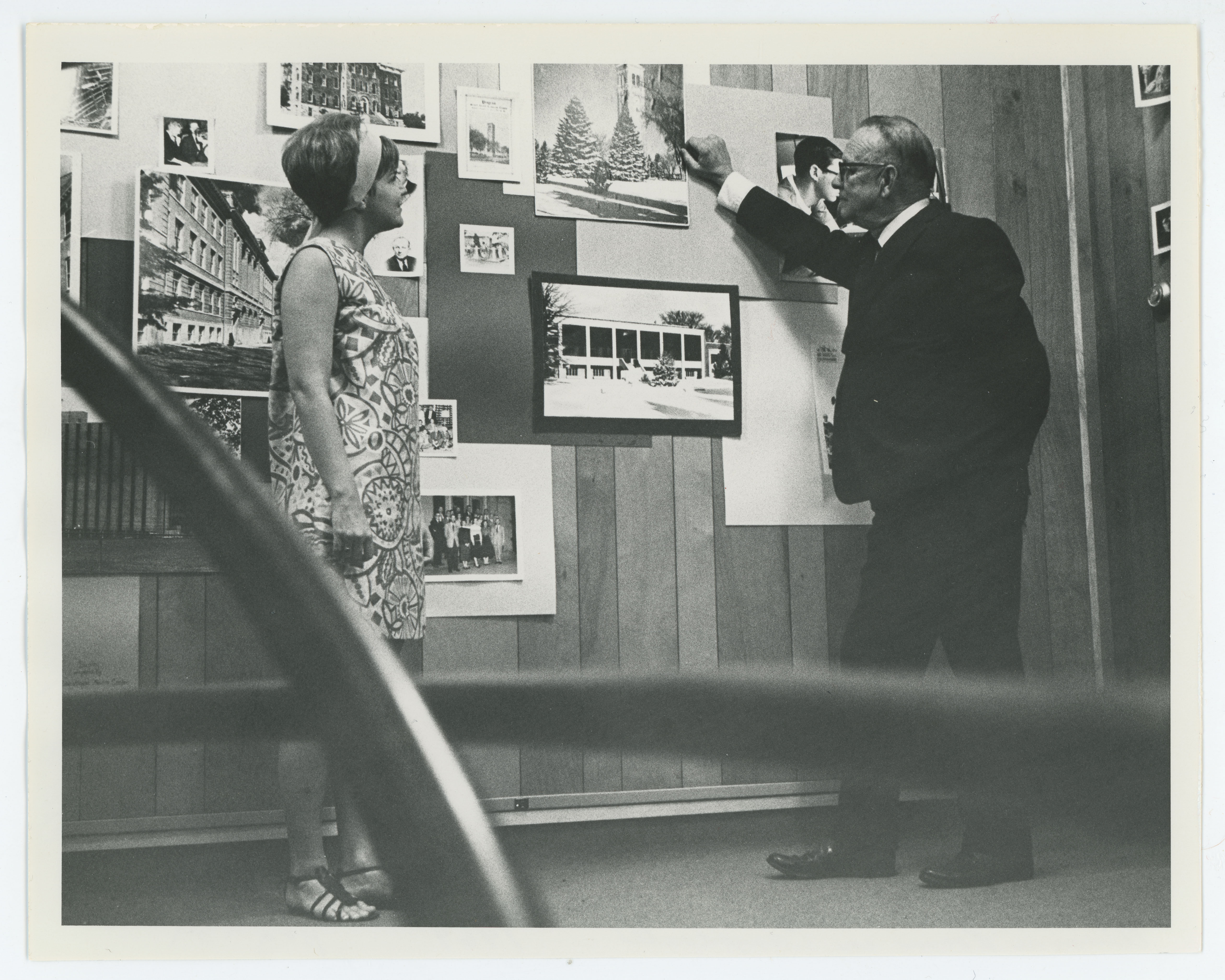 Woman and man in Alumni Room in Campanile looking at art