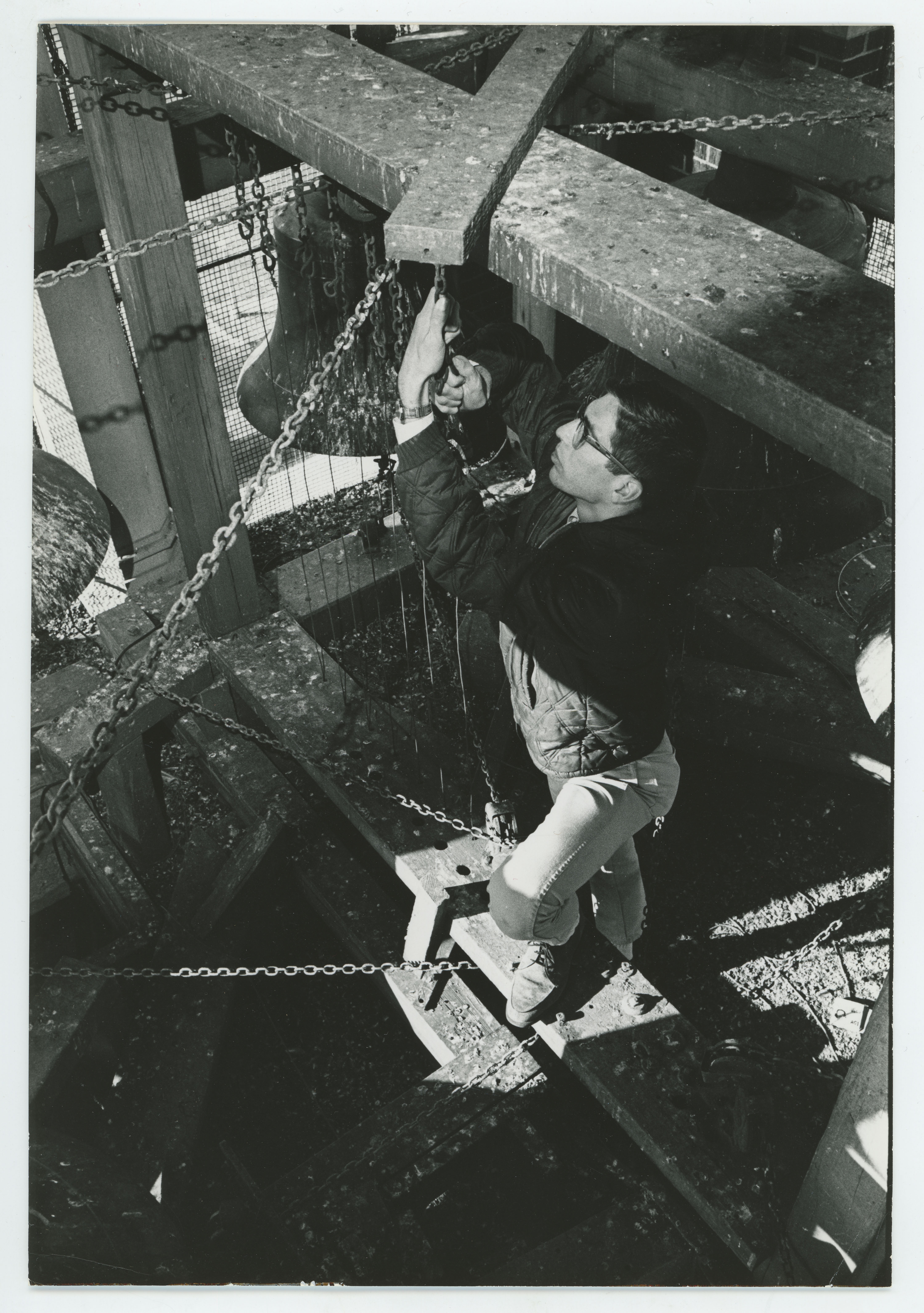 Man pulling chain to ring bell in Campanile