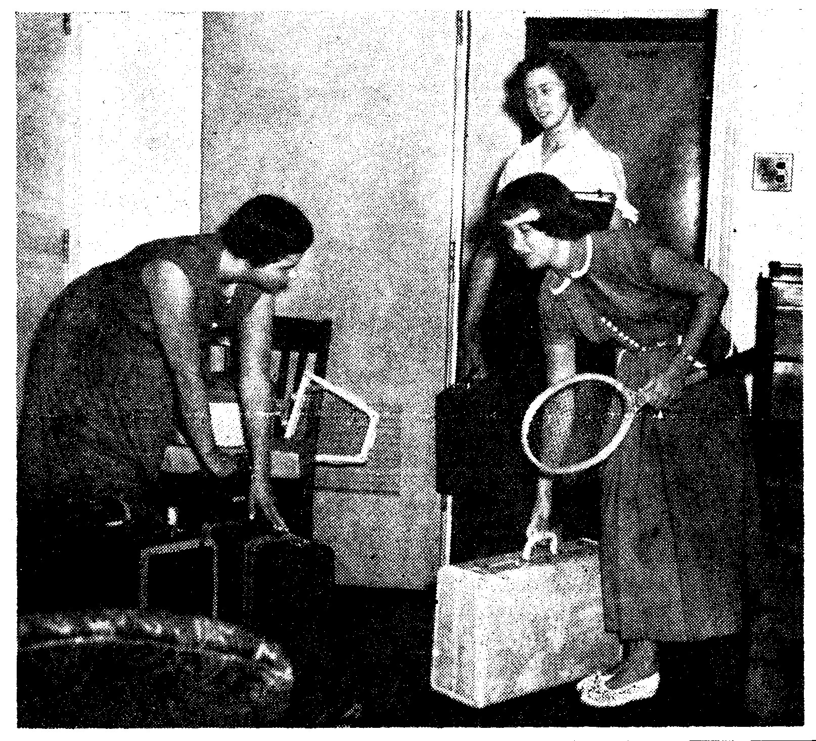 Newspaper photo of three women moving into dorm room with luggage
