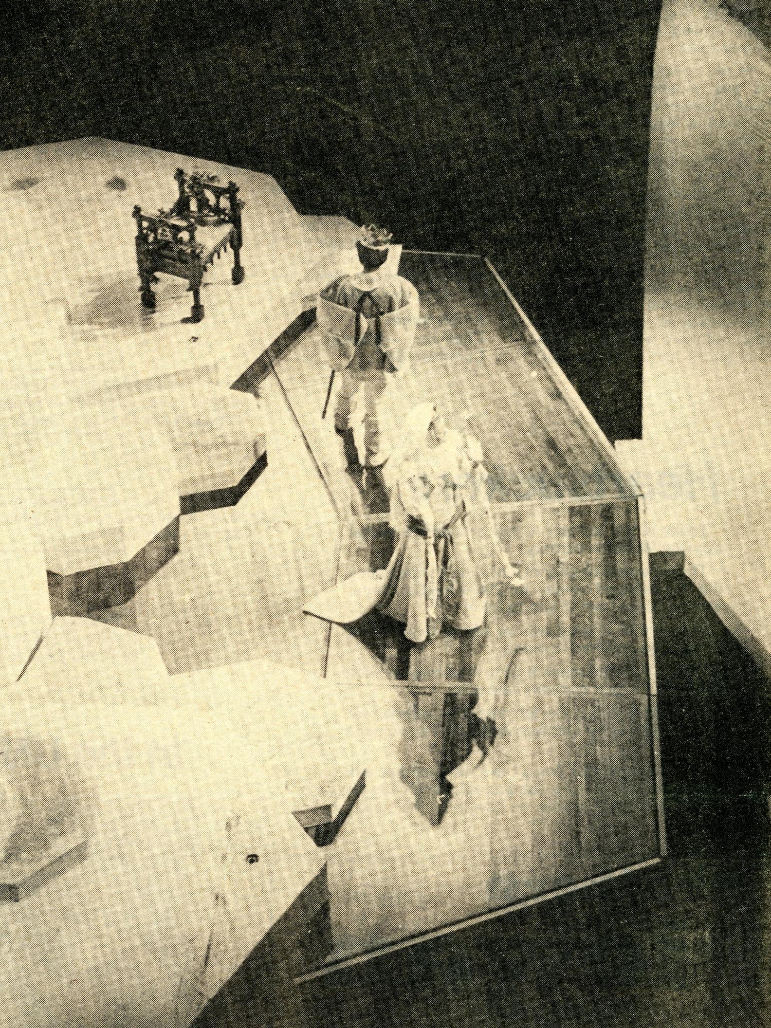 Printed in the newspaper, a woman and man on stage dressed in medieval clothes giving a performance