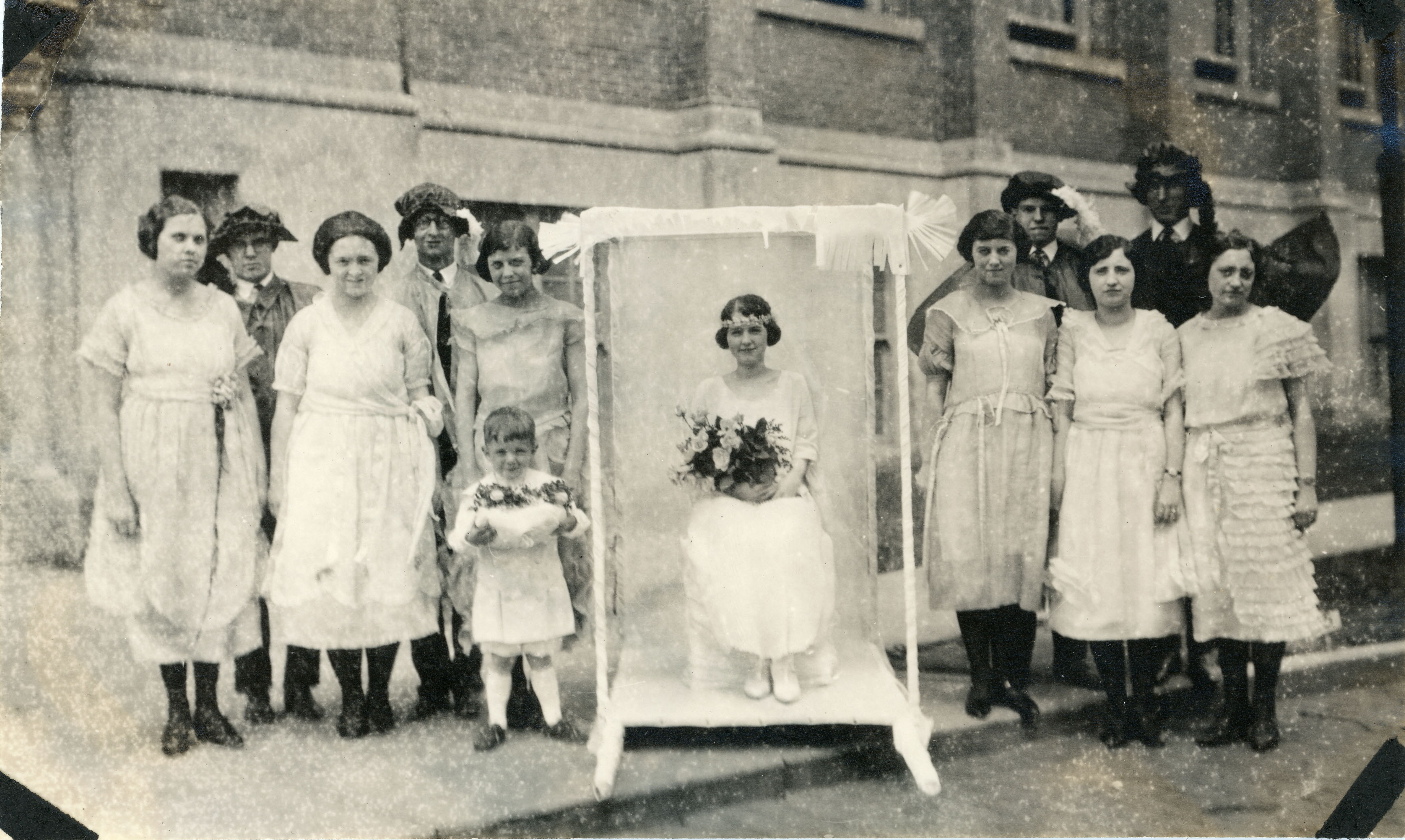 A May queen on her throne with her court