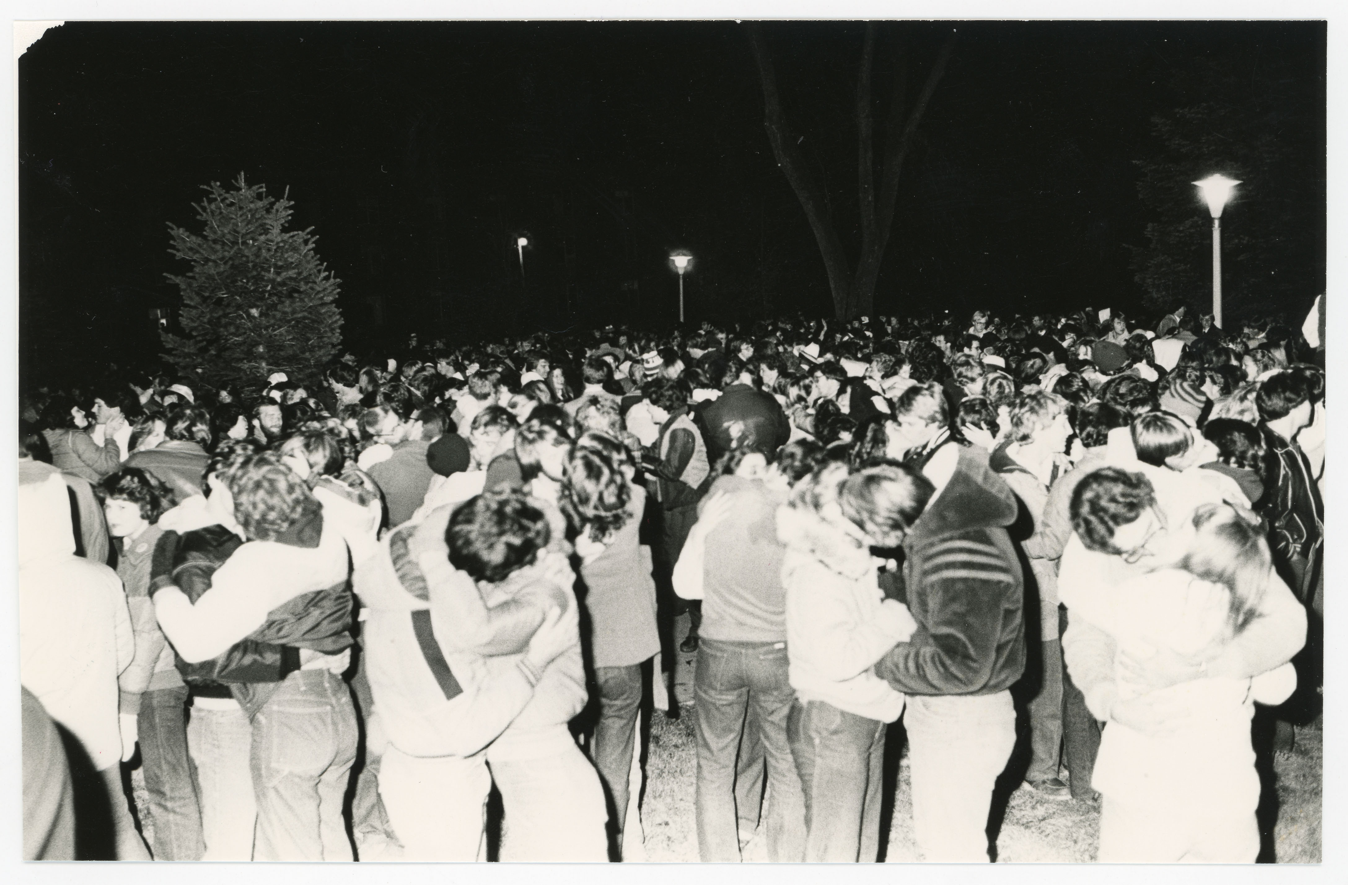 Crowd of couples kissing at night