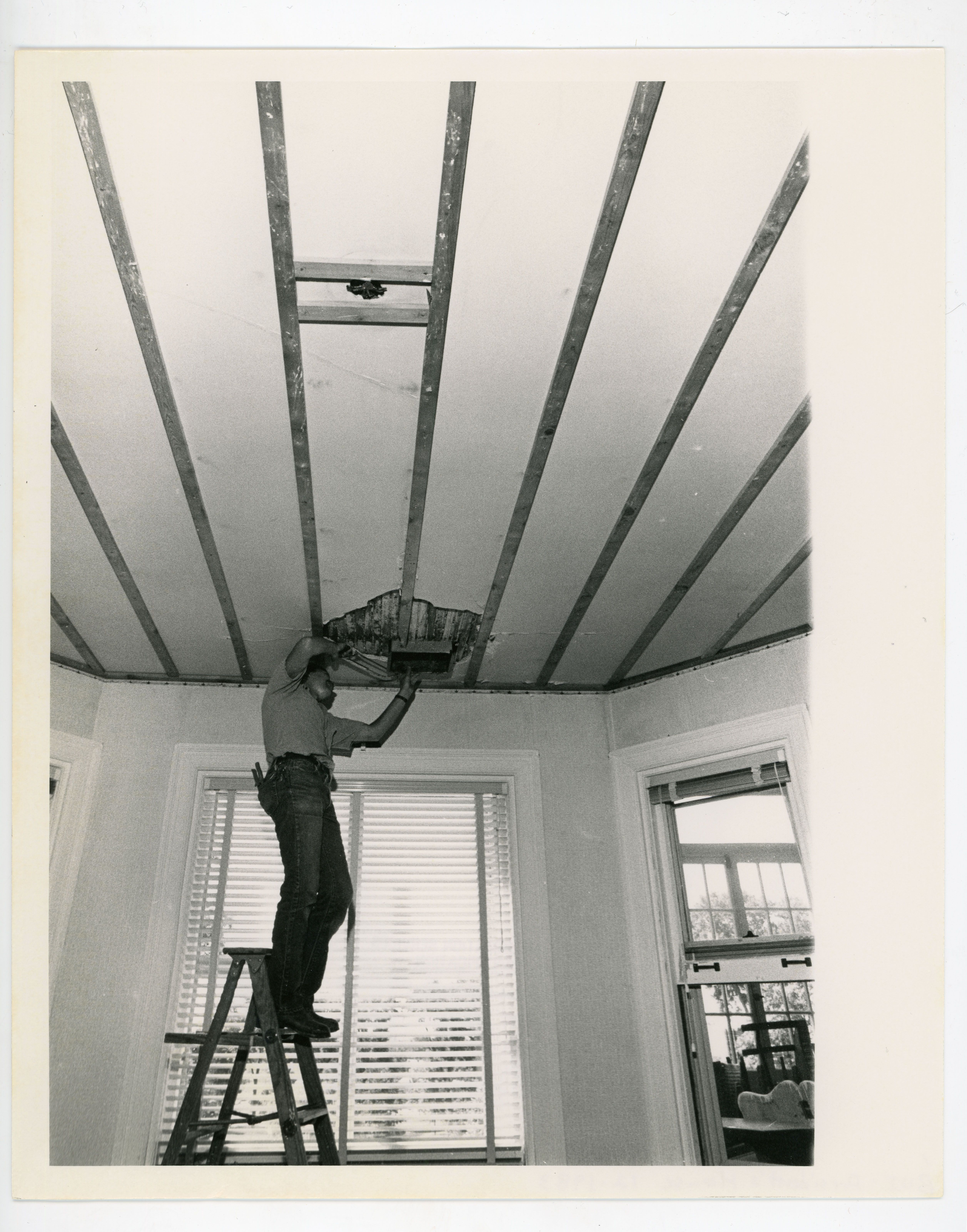 Person on a ladder working during President's home renovations