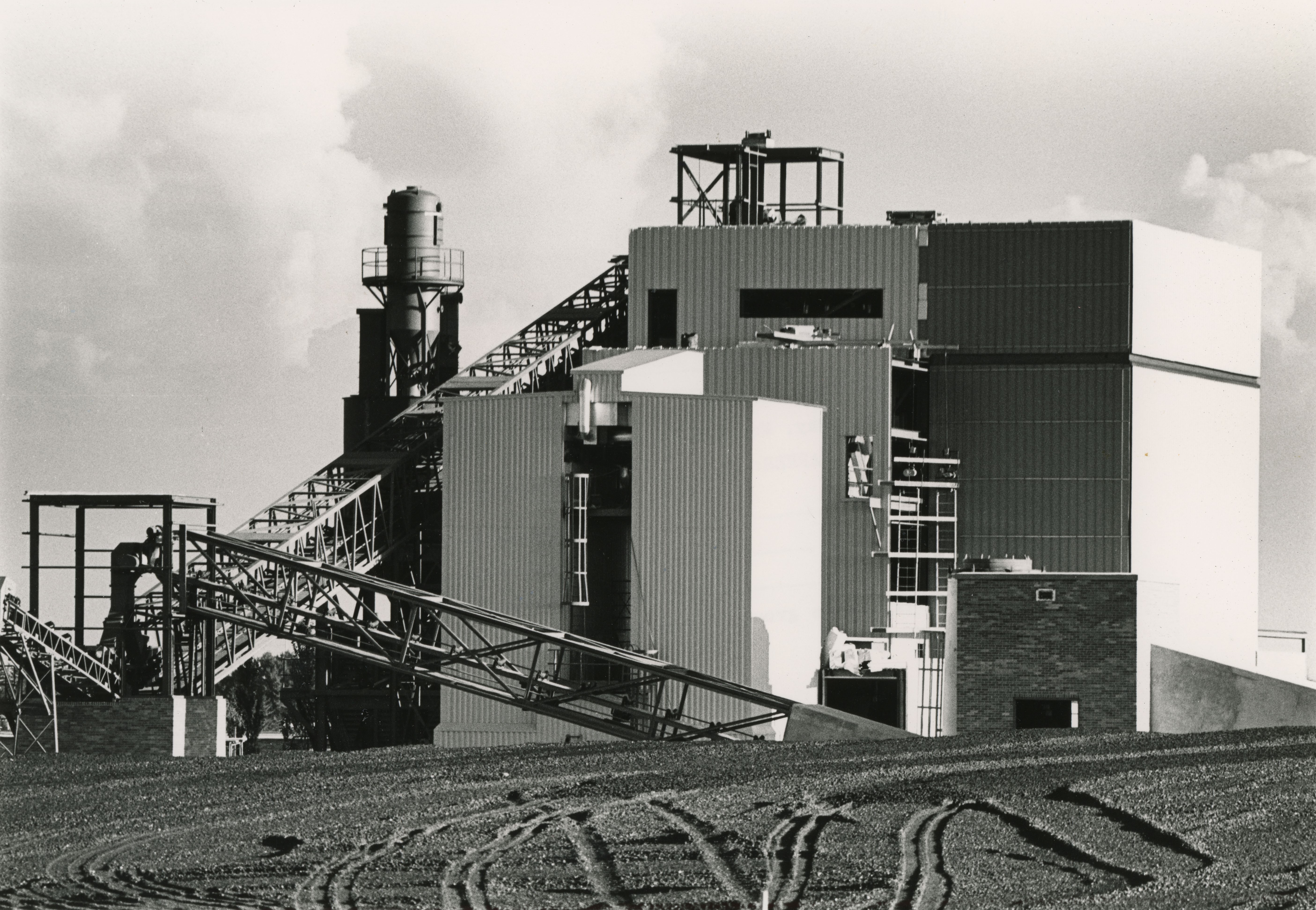 A complex of power plant buildings with steel siding and catwalks
