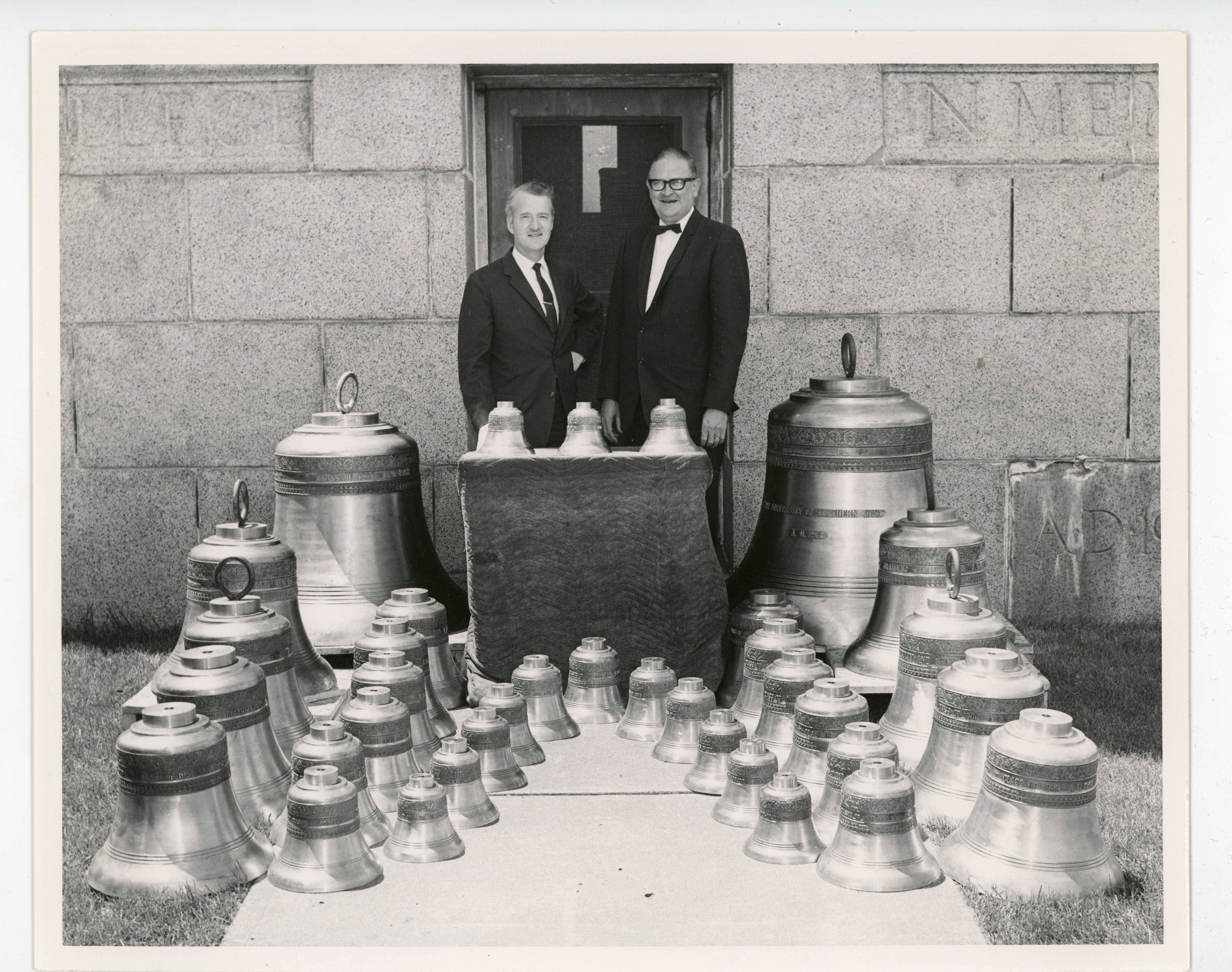 President Maucker and T. Wayne Davis standing behind an array of bells