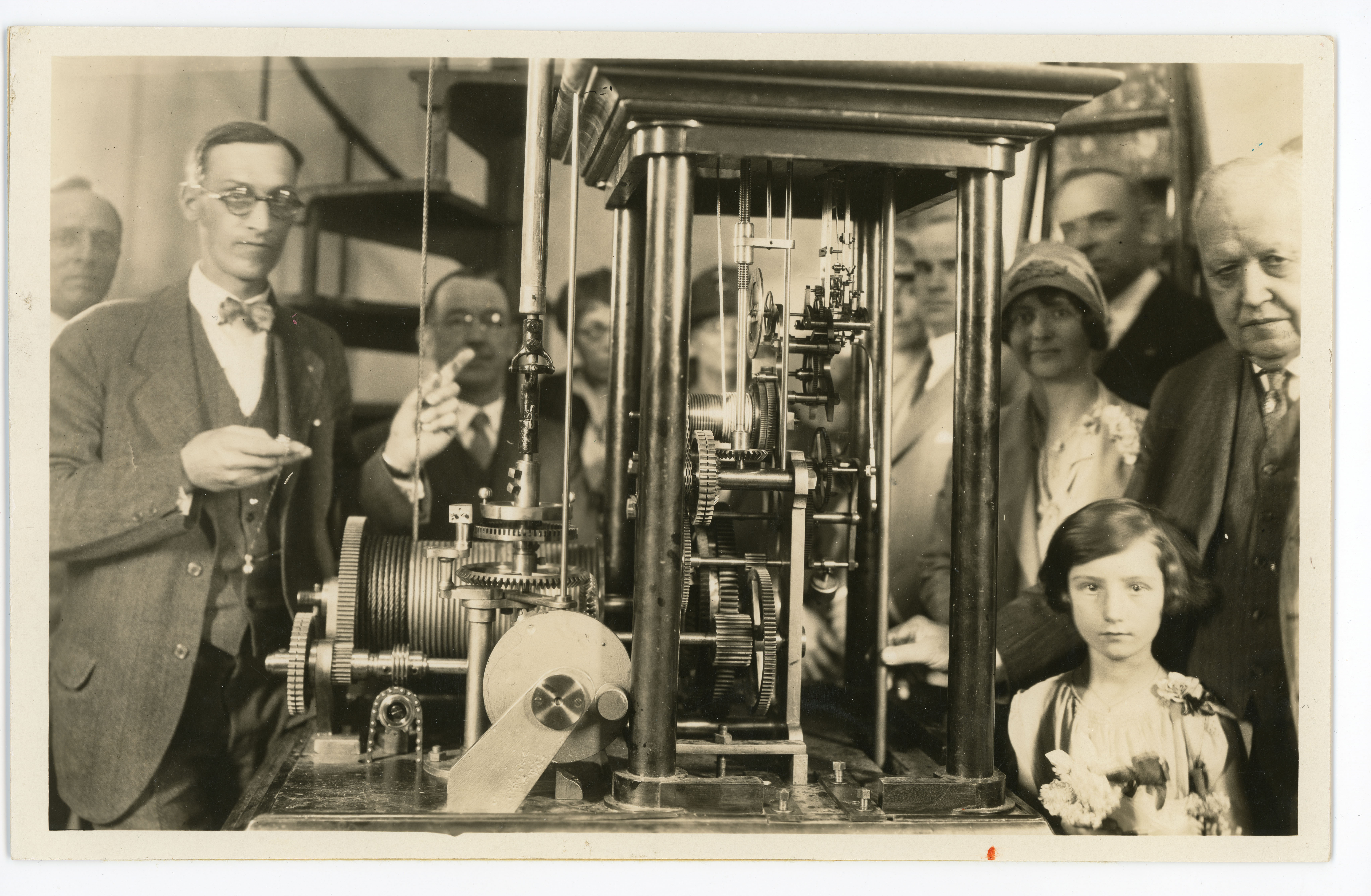 Fasoldt clock mechanism ready for release with people gathered around