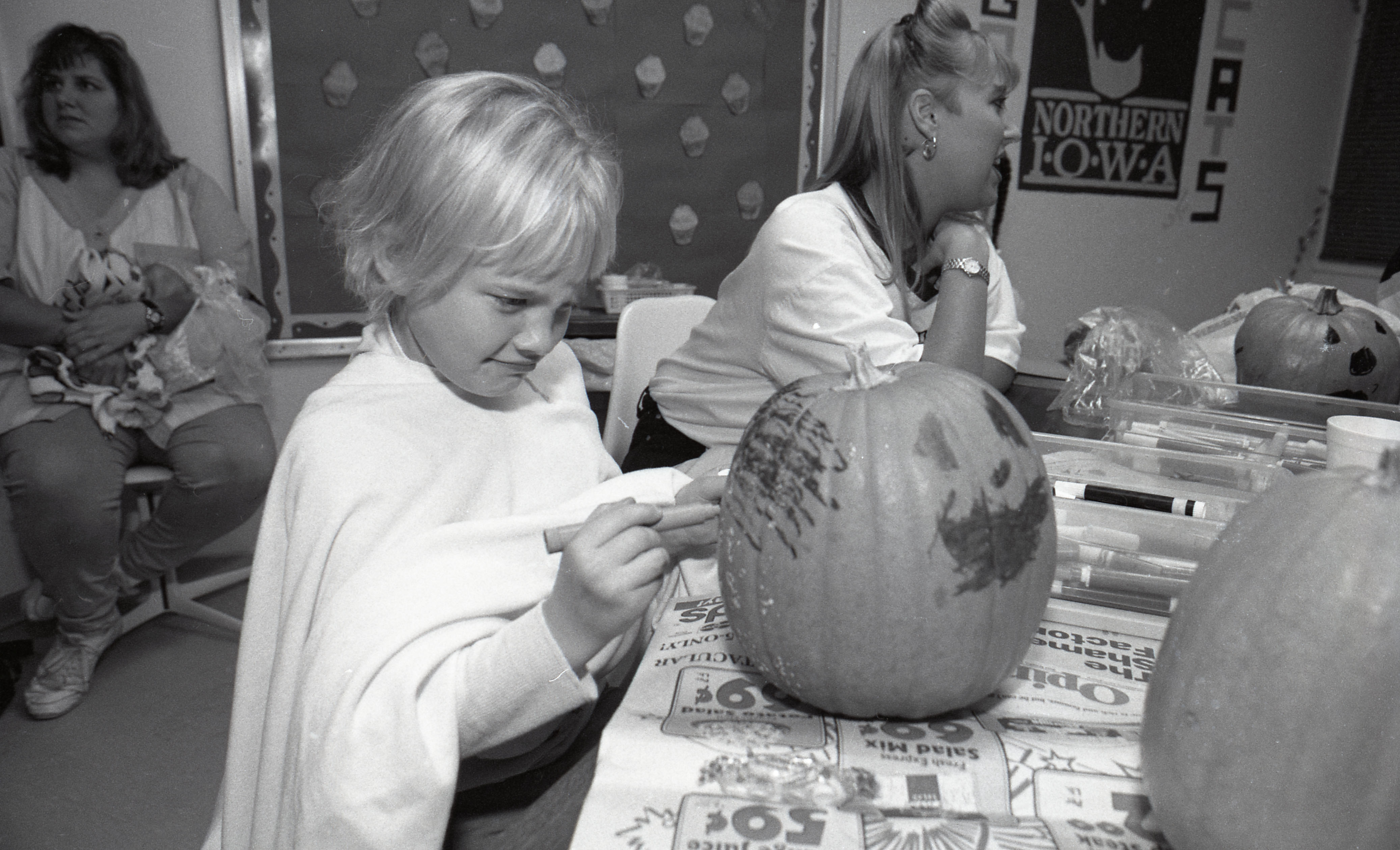 A child decorating a pumpkin