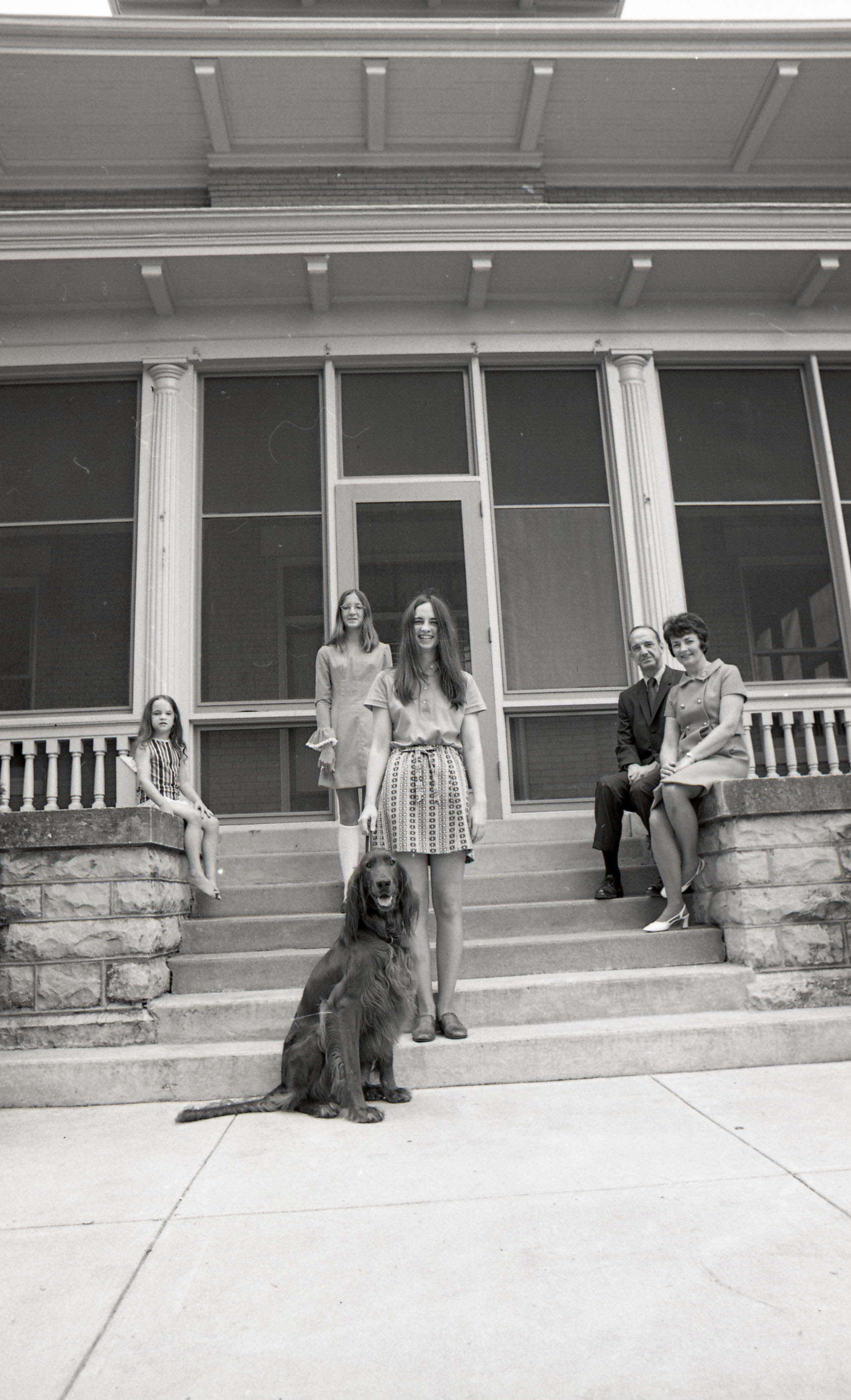 President Kamerick and his family with their dog on the steps of the President's House