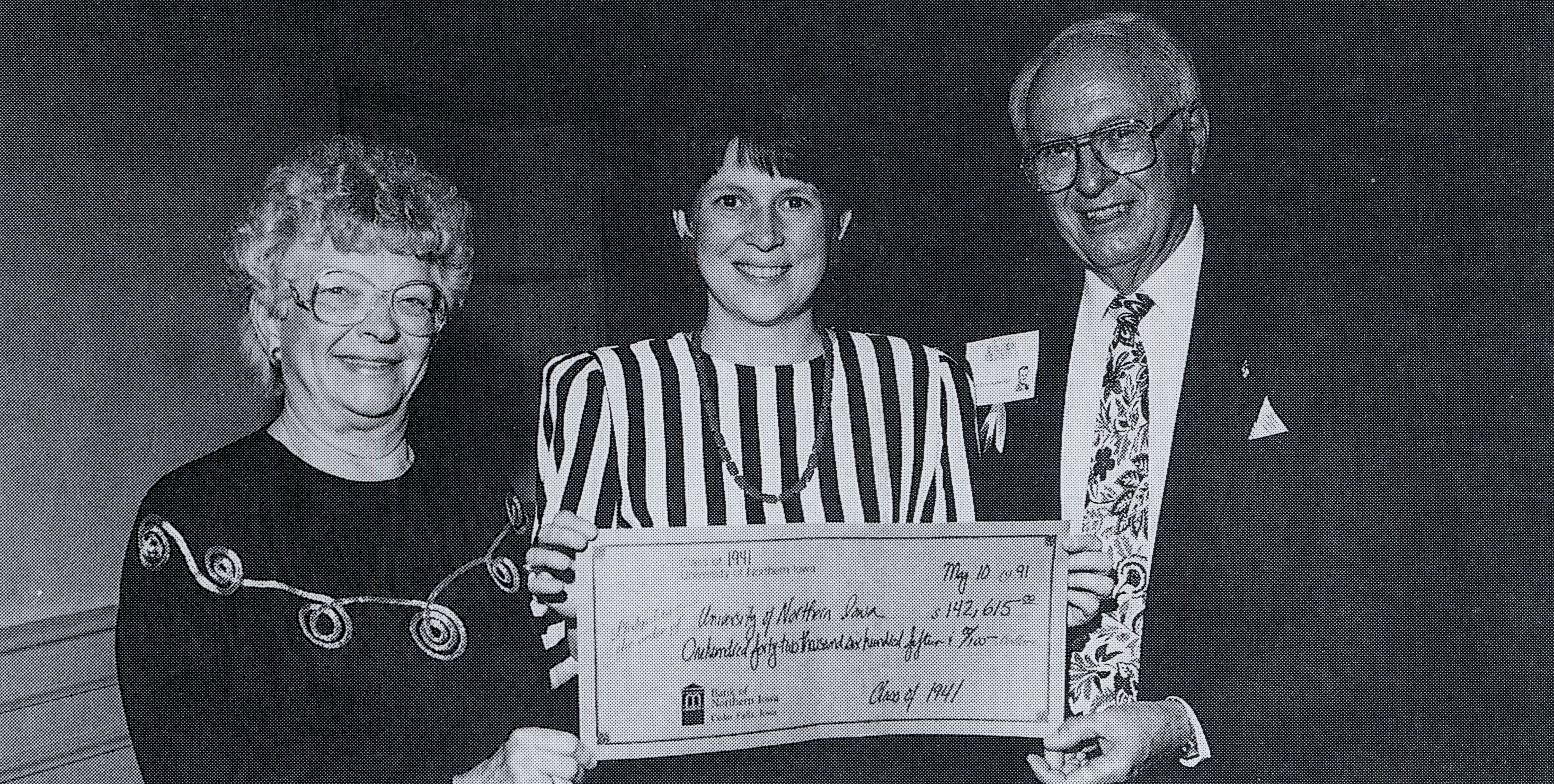 Dee Vandeventer, center, accepting a check from a Golden Reunion class