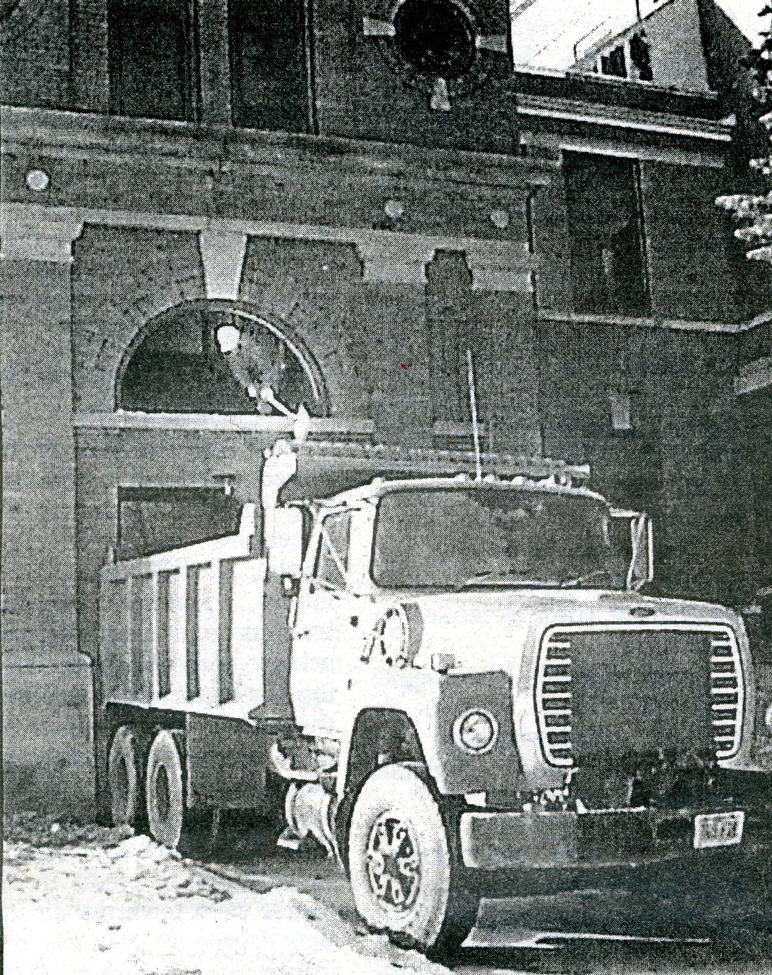 Dump truck hauling out debris from Lang Hall renovations