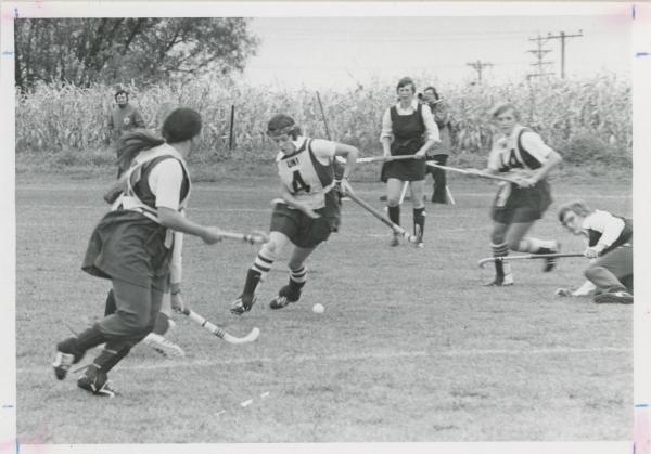 Women playing field hockey, 1974