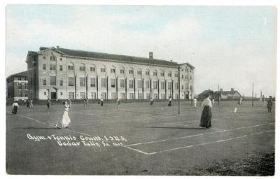 Photo of women playing tennis on the west side of the East Gym