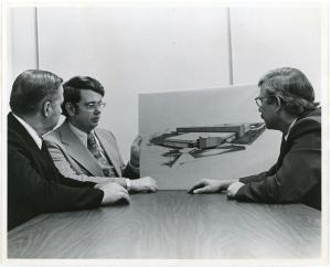 UNI planning administrator Leland Thomson, architect Geoffrey Grimes, and faculty member Alvin Rudisill sitting at at a table and looking at plans for the ITC
