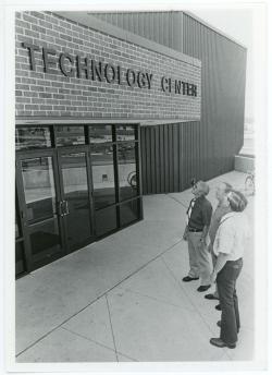 Professors Alvin Rudisill, Ron Bro, and Rex Pershing looking up at new lettering on the ITC