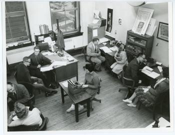 Photograph of the Lang Hall faculty offices where several professors are meeting with students