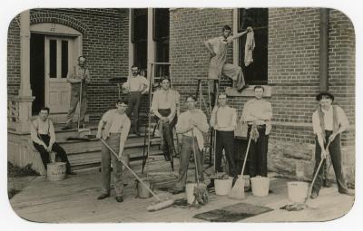 Custodial staff and student volunteers posing in front of old Gilchrist Hall.