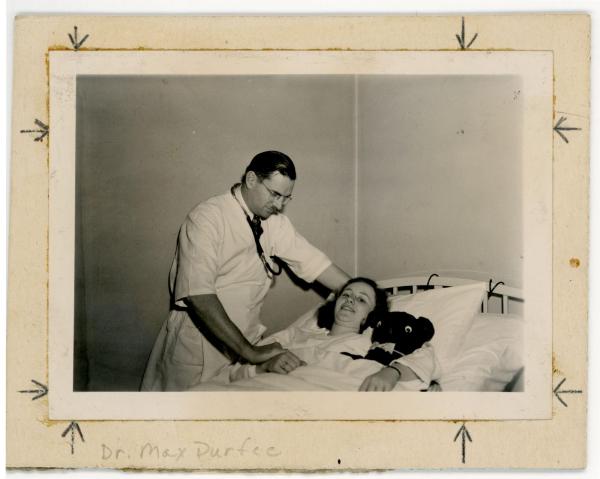 Photograph of Dr. Max Durfee attending to a student