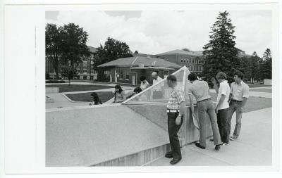 A group of people around a set of stairs down to the union, the Union Craft Shop is in the background