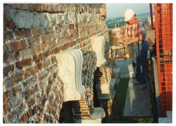 Mason inspecting the bricks near the top of the Campanile