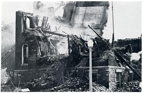 Photograph of the Central Hall ruins being knocked down after the fire
