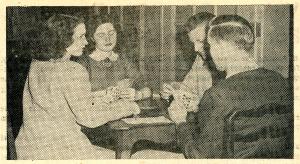 Four students playing cards in the Commons