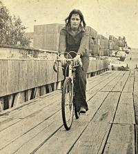 A person riding a bike across the pedestrian and bicycle bridge to Hillside Courts