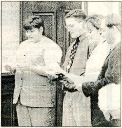 Photograph of NISG representatives serenading Governor Branstad in Lang Hall