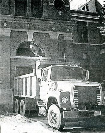 Photograph of a dump truck removing debris from demolition