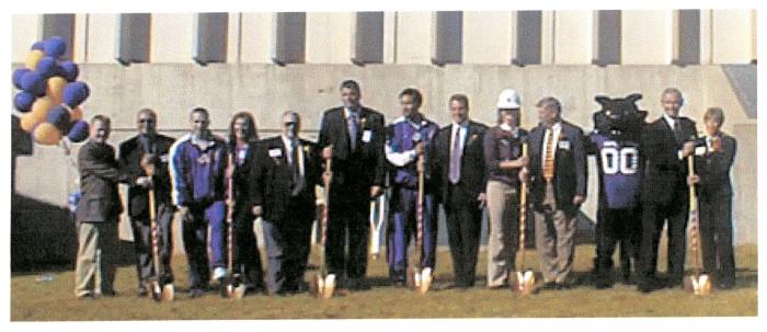 Group holding golden shovels lined up for McLeod Groundbreaking ceremony