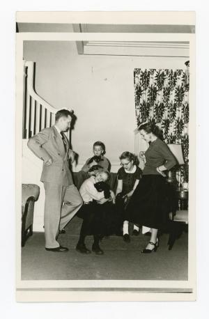 The Maucker family and their pets posing for a photo on a staircase in the President's House
