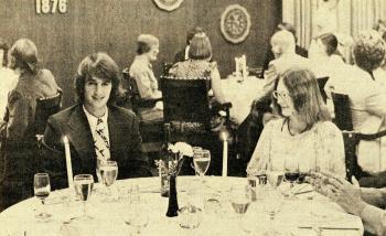 People in formal wear sitting at tables during a Wine and Dine program