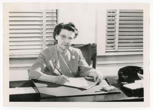 Photograph of Dean of Women Sadie B. Campbell sitting at her desk 