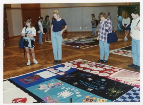 People looking over the AIDS Quilt
