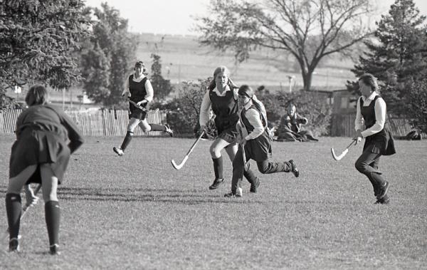 Women playing field hockey, 1972