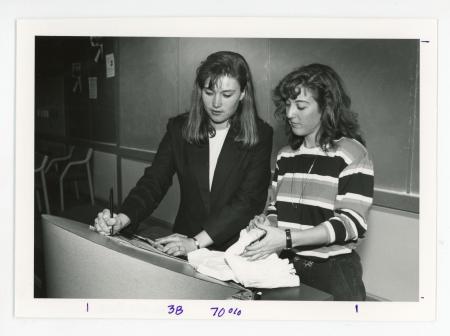 Amy Hassler and Deb Henrich standing in front of a podium.