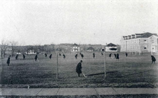 Women playing field hockey, about 1918.