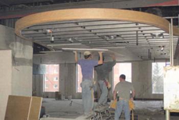 Workers installing part of the ceiling in the Redeker Center dining area