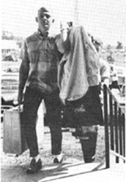 Individual carrying their belongings into Schull Hall during move-in day