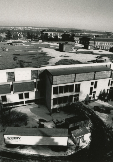 Aerial view of snowy building with construction equipment around it