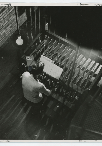 Man playing carillon keyboard with sheet music