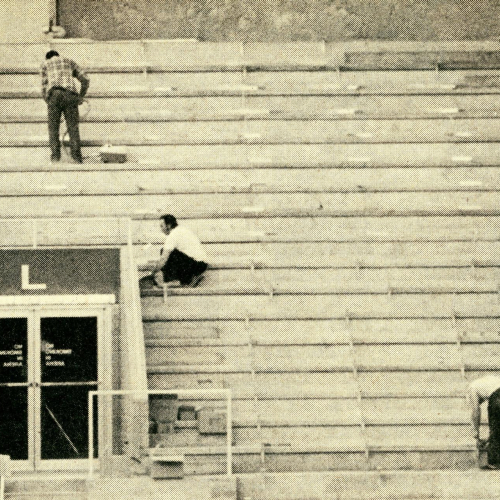 Workers installing stadium seats in UNI-Dome