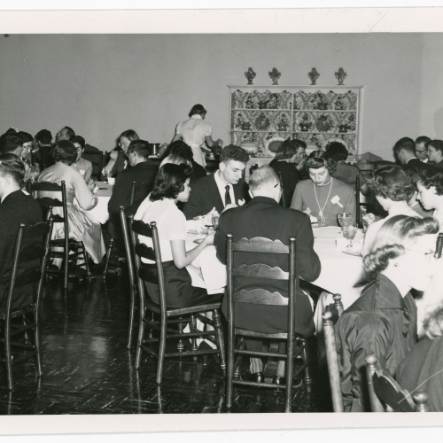 Crowd eating at round tables