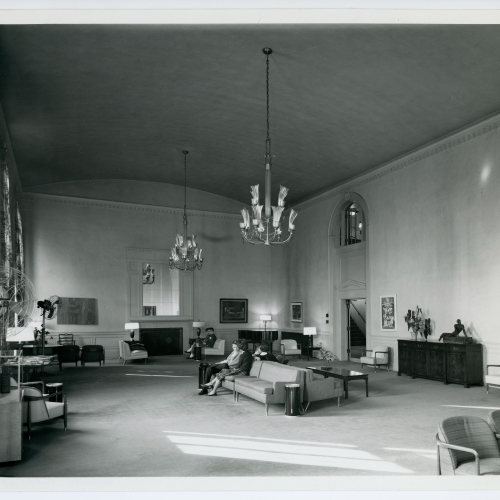 Six scattered students seated on couches in Commons sitting room
