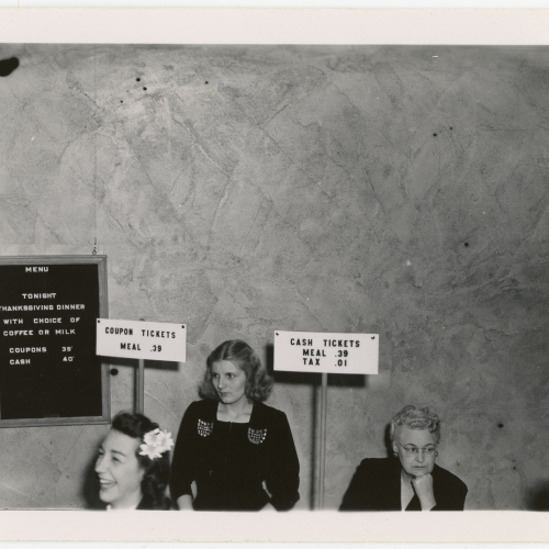 Two women selling meal tickets; menu board includes Thanksgiving Dinner and ticket prices are 39 cents with coupon ticket and 40 cents with cash ticket