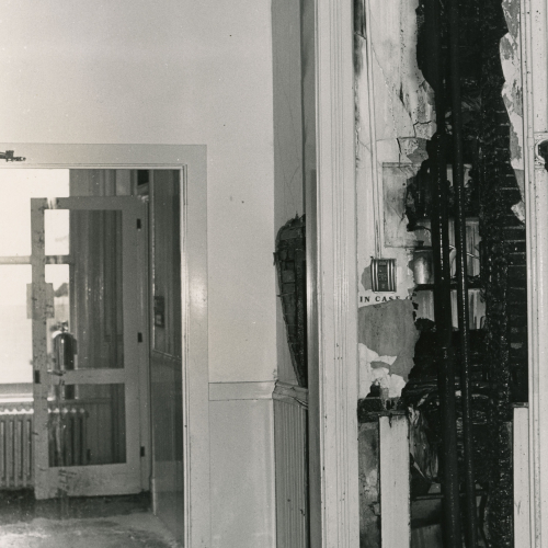 Fire damage exposing pipes and electric work inside a building